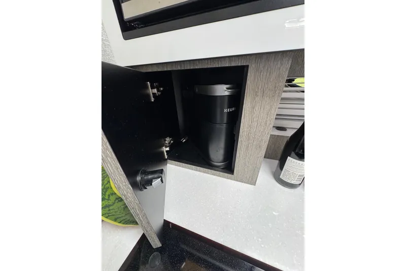 Slide: The Image of Compact coffee maker in 2021 Monterey 335 Sport Yacht kitchen cabinet. - 29