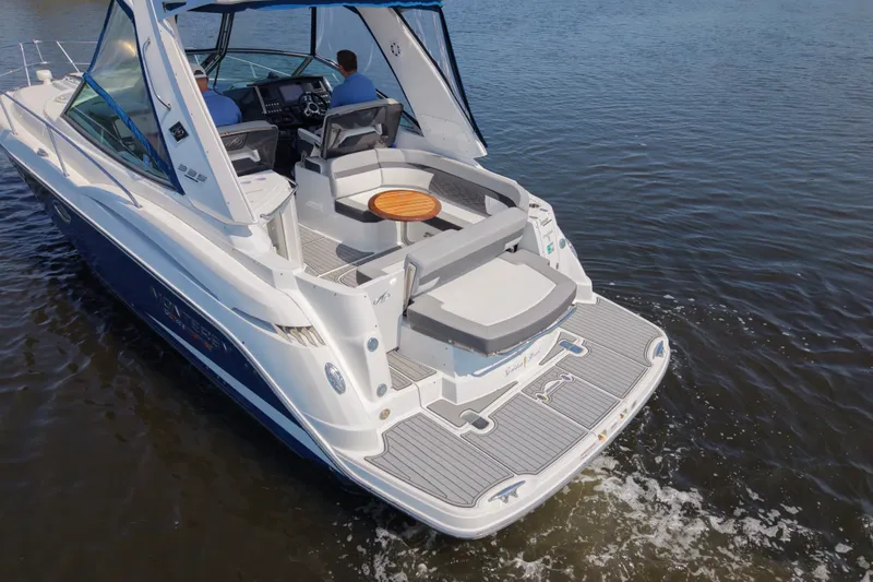 Slide: The Image of 2021 Monterey 335 Sport Yacht cruising on calm water, rear view. - 6