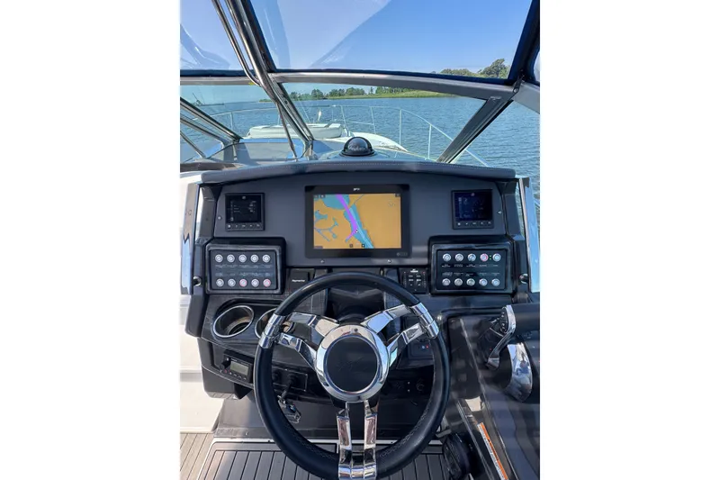 Slide: The Image of Cockpit view of 2021 Monterey 335 Sport Yacht with navigation screens and steering wheel. - 45