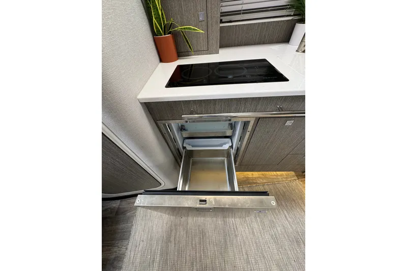 Slide: The Image of Modern kitchen in 2021 Monterey 335 Sport Yacht with open drawer and sleek countertop. - 27