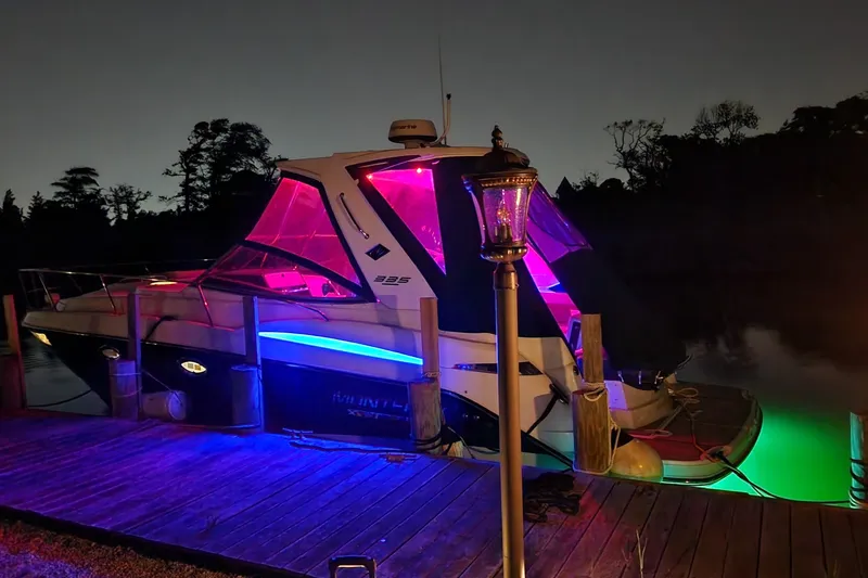 Slide: The Image of 2021 Monterey 335 Sport Yacht docked at night with vibrant LED lighting. - 59