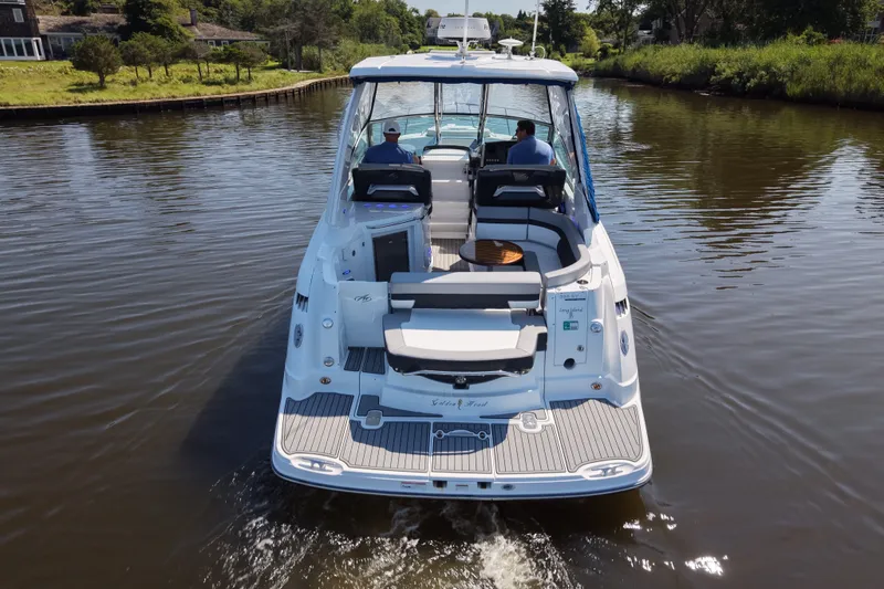 Slide: The Image of 2021 Monterey 335 Sport Yacht cruising on a serene river, showcasing sleek design and luxury. - 23