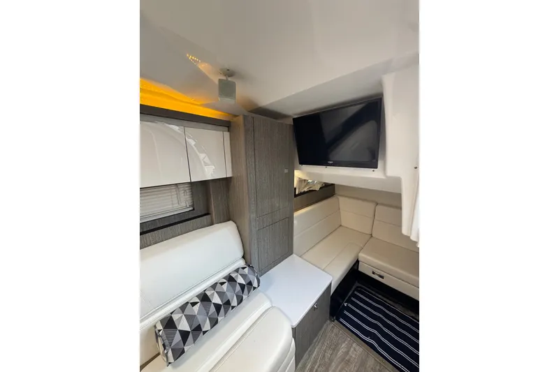 Slide: The Image of Interior of 2021 Monterey 335 Sport Yacht with modern seating and wall-mounted TV. - 34