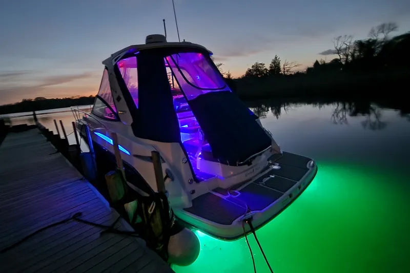Slide: The Image of 2021 Monterey 335 Sport Yacht docked at sunset with vibrant LED lighting. - 60