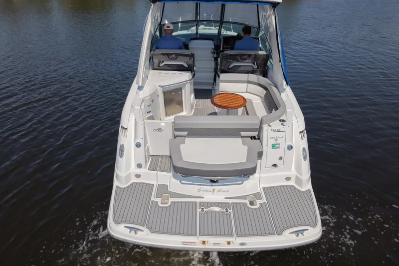 Slide: The Image of 2021 Monterey 335 Sport Yacht cruising on calm water, showcasing spacious deck and seating area. - 8