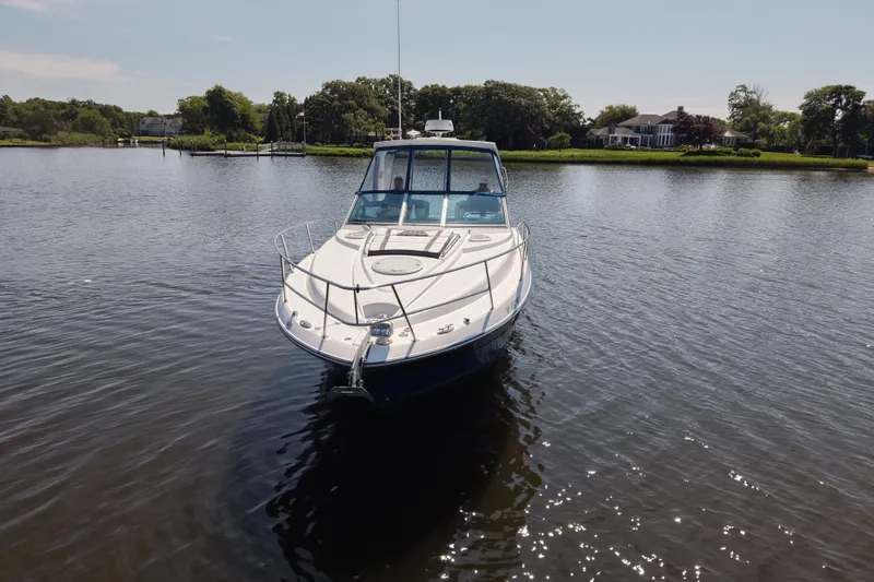 Slide: The Image of 2021 Monterey 335 Sport Yacht on calm water near a scenic shoreline. - 3