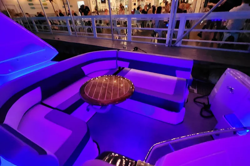 Slide: The Image of Luxurious seating area on a 2021 Monterey 335 Sport Yacht with ambient lighting. - 62