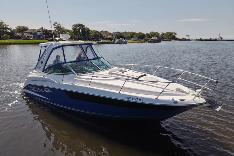 The Image of 2021 Monterey 335 Sport Yacht cruising on a serene lake. - 1