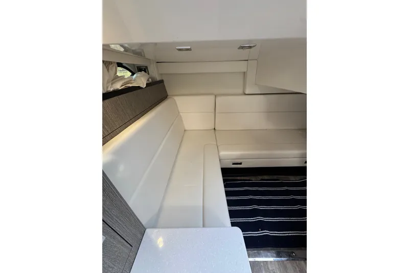 Slide: The Image of Interior of 2021 Monterey 335 Sport Yacht with white seating and modern design. - 36