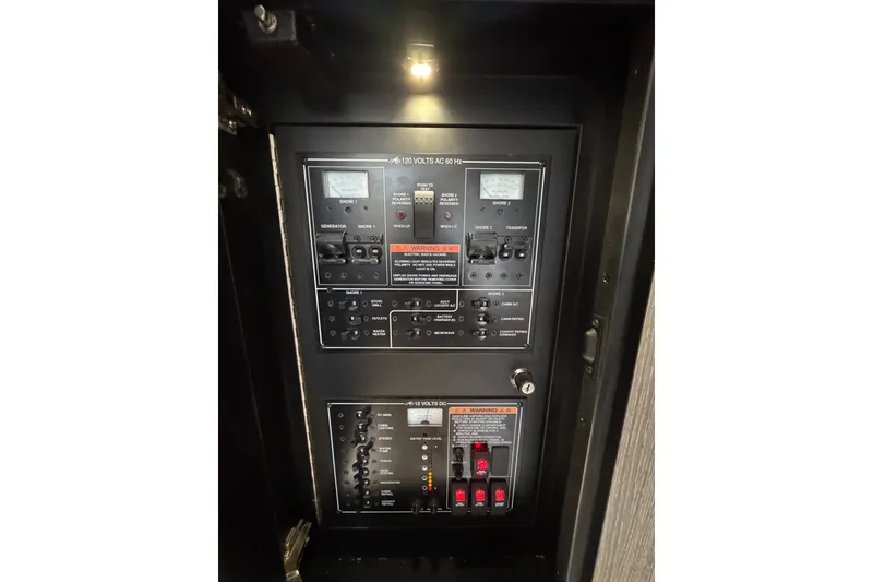 Slide: The Image of Electrical control panel on a 2021 Monterey 335 Sport Yacht, illuminated and detailed. - 43