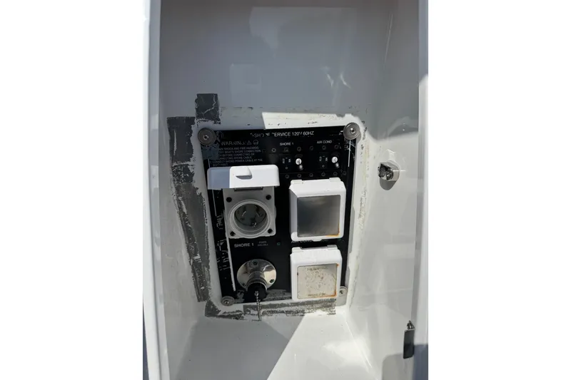 Slide: The Image of Electrical panel on a 2021 Monterey 335 Sport Yacht, featuring shore power connections. - 63