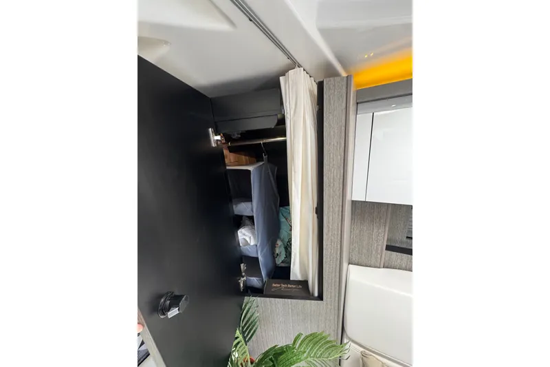 Slide: The Image of Interior of the 2021 Monterey 335 Sport Yacht with a closet and plants. - 33