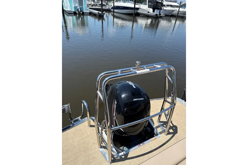 Slide: The Image of 2024 Harris Cruiser 230 pontoon boat with Mercury engine at marina dock. - 9