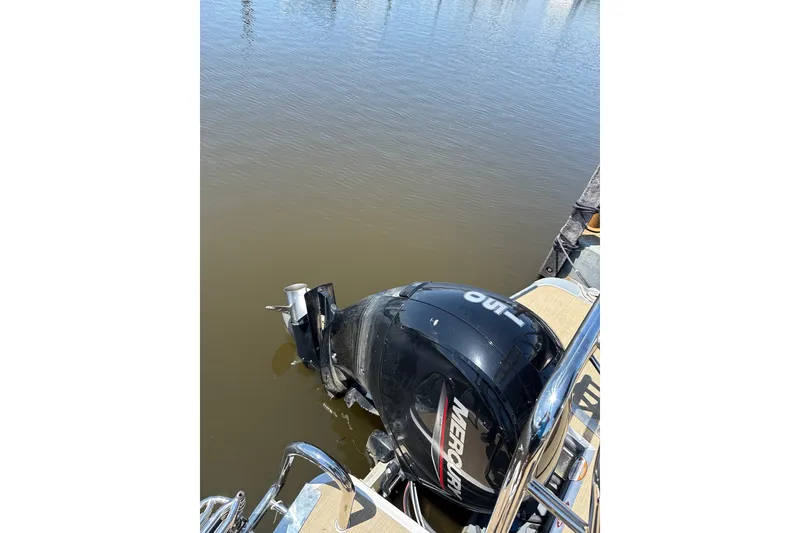 Slide: The Image of 2024 Harris Cruiser 230 with Mercury outboard motor on calm water. - 11