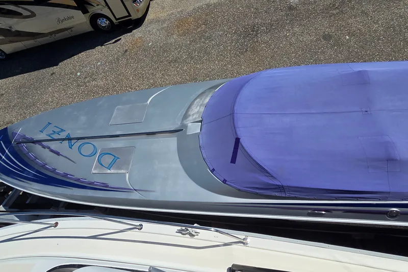 Slide: The Image of 2006 Donzi 38 ZR boat with purple cover, viewed from above. - 8