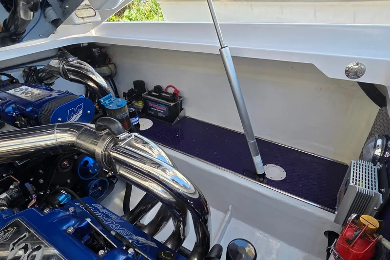 Slide: The Image of Engine compartment of 2006 Donzi 38 ZR boat with polished components and battery. - 7