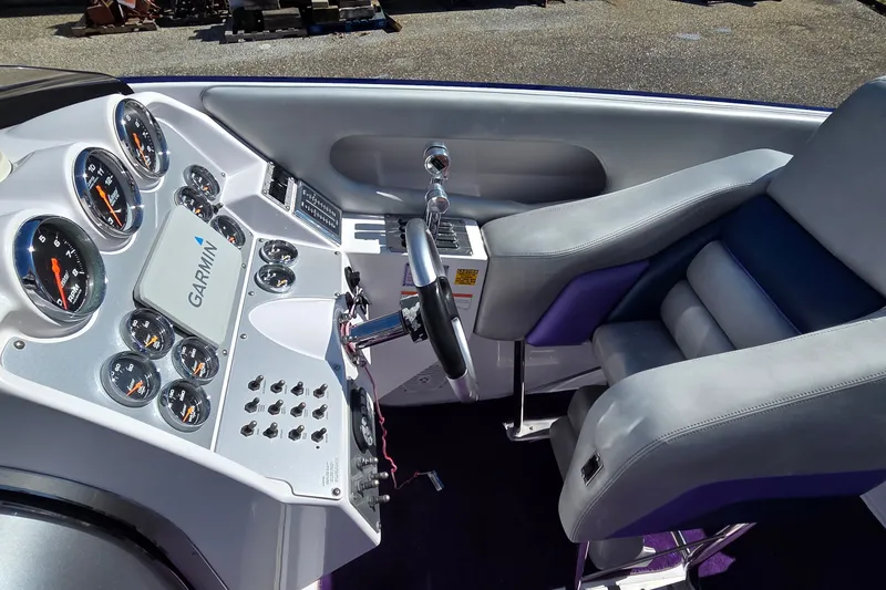 Slide: The Image of 2006 Donzi 38 ZR boat cockpit with Garmin navigation and sleek controls. - 34