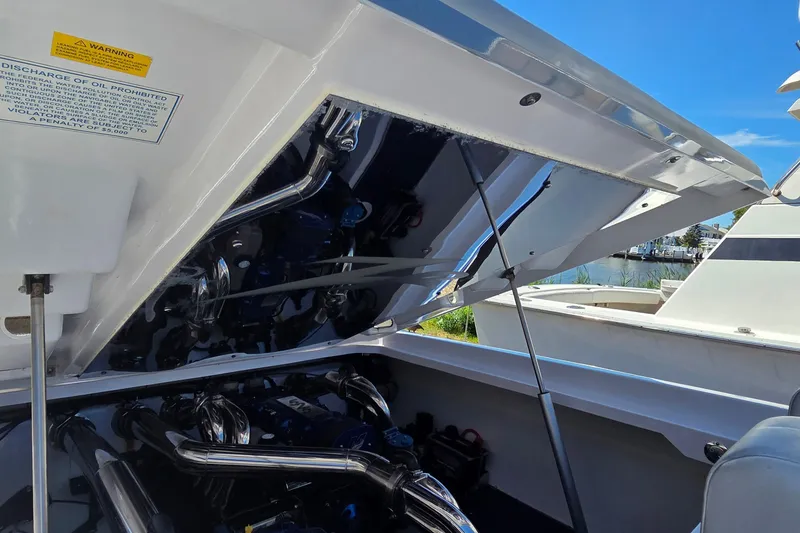 Slide: The Image of Engine compartment of a 2006 Donzi 38 ZR boat with open hatch, showing chrome components. - 14