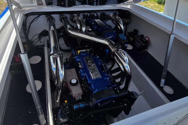 Slide: The Image of Engine compartment of a 2006 Donzi 38 ZR boat, featuring dual high-performance engines. - 6