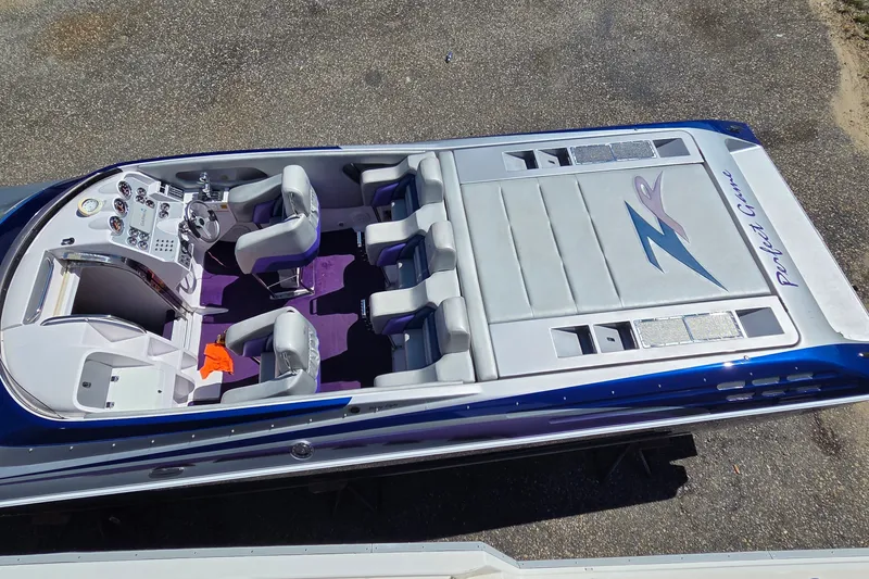 Slide: The Image of 2006 Donzi 38 ZR speedboat with purple interior and sleek design, viewed from above. - 28