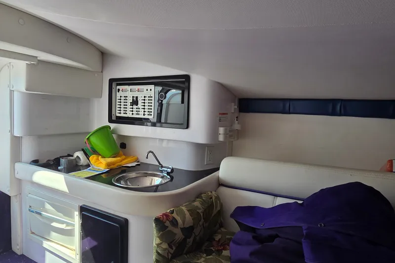 Slide: The Image of Interior of a 2006 Donzi 38 ZR boat featuring a compact kitchenette area. - 27