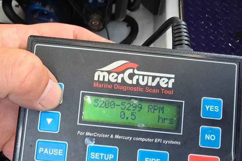Slide: The Image of Hand holding MerCruiser diagnostic tool displaying 5200-5299 RPM for 2006 Donzi 38 ZR. - 22