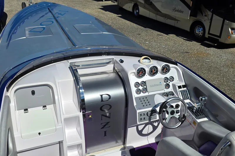 Slide: The Image of 2006 Donzi 38 ZR boat cockpit with Garmin navigation and sleek dashboard design. - 30