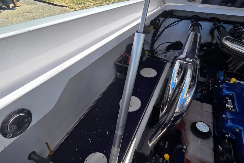 Slide: The Image of Engine compartment of a 2006 Donzi 38 ZR boat, showcasing polished components and mechanical details. - 9