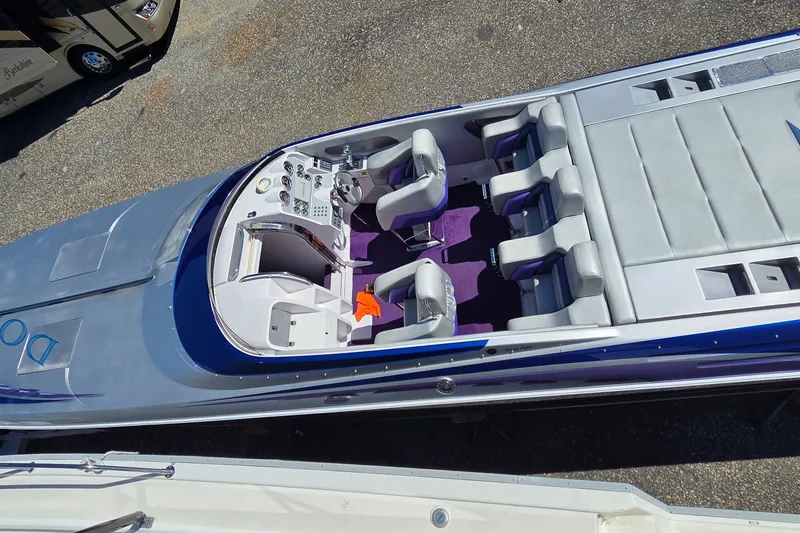 Slide: The Image of 2006 Donzi 38 ZR speedboat with sleek design and purple interior seating. - 29