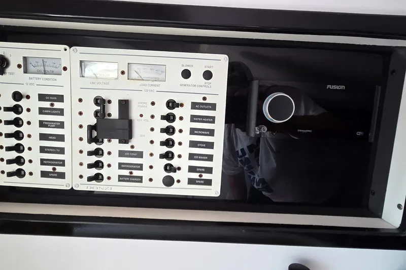 Slide: The Image of Electrical control panel of a 2006 Donzi 38 ZR boat with various switches and gauges. - 38