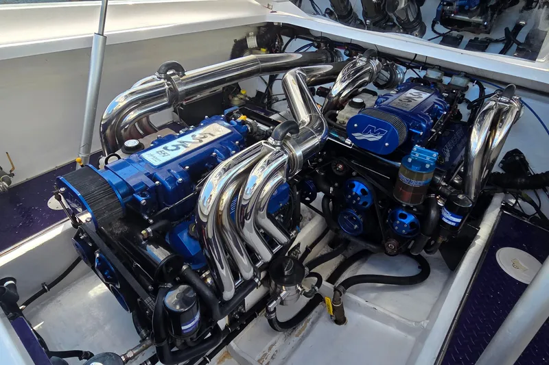 Slide: The Image of 2006 Donzi 38 ZR engine compartment with polished chrome and blue components. - 5