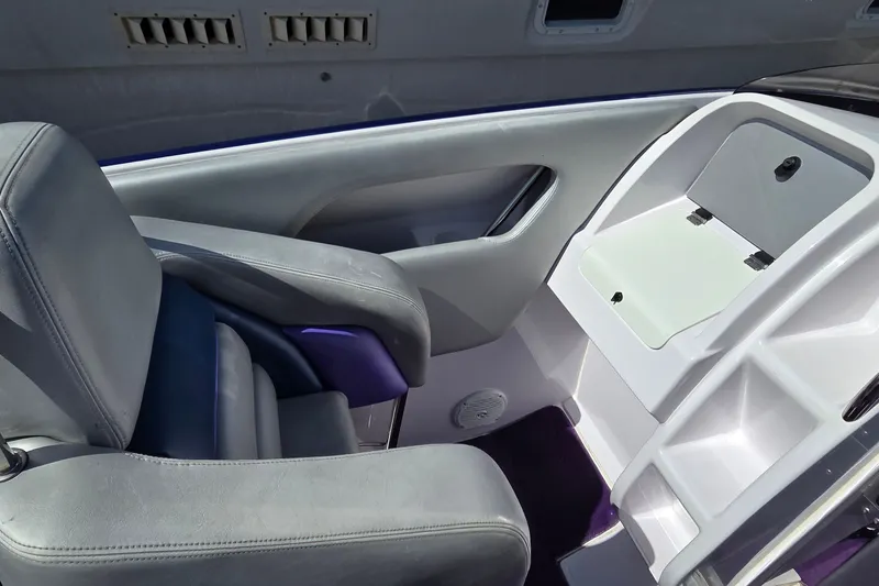 Slide: The Image of Interior of a 2006 Donzi 38 ZR boat, featuring sleek seating and storage compartment. - 33