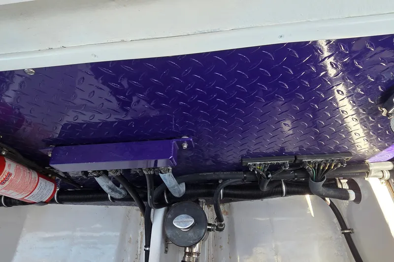 Slide: The Image of Engine compartment of a 2006 Donzi 38 ZR with purple diamond plate paneling. - 12