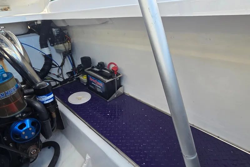 Slide: The Image of 2006 Donzi 38 ZR engine compartment with battery and wiring details. - 13