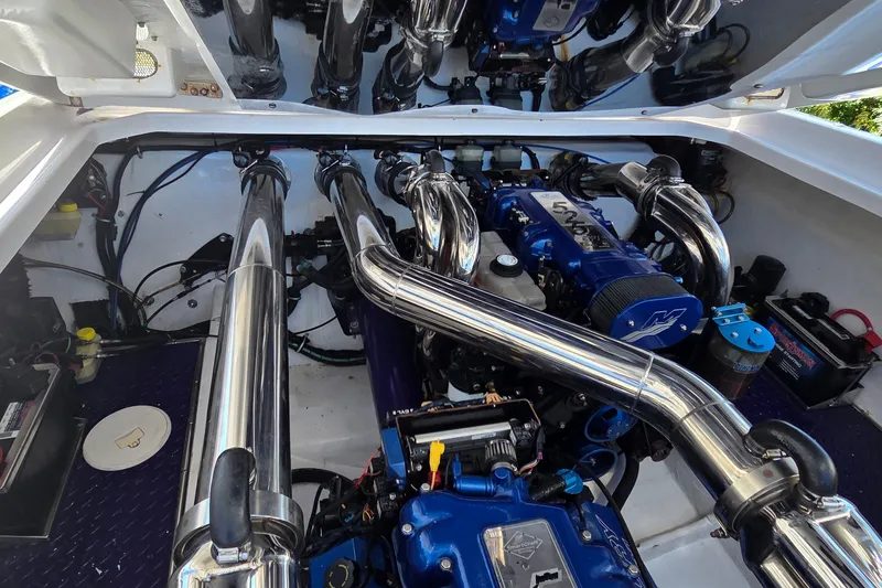 Slide: The Image of Engine compartment of a 2006 Donzi 38 ZR with polished components and blue accents. - 4