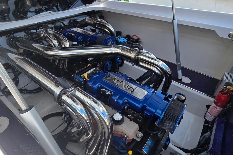 Slide: The Image of Engine compartment of a 2006 Donzi 38 ZR with polished components and blue accents. - 15