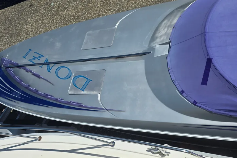 Slide: The Image of 2006 Donzi 38 ZR boat with sleek design and purple cover, viewed from above. - 10