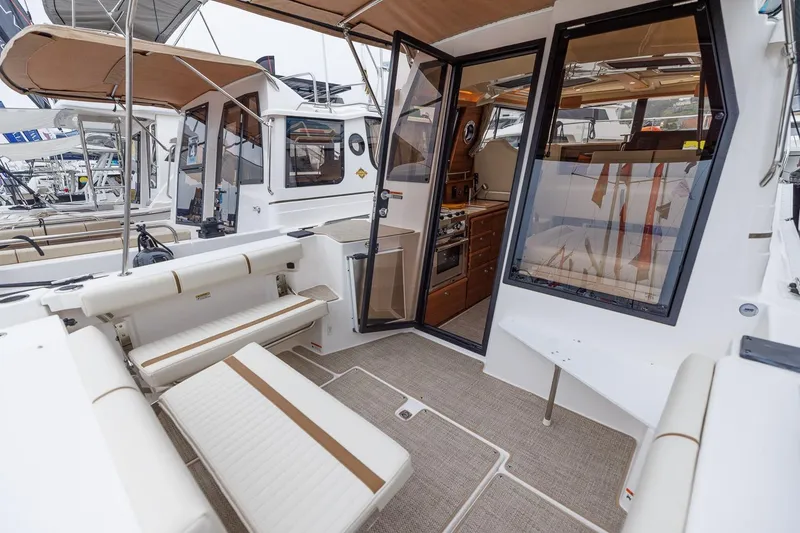 Slide: The Image of 2026 Ranger Tugs R-27 boat interior with seating and kitchen area. - 15