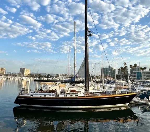 Slide: The Image of 1981 Little Harbor Cruiser sailboat docked in a marina under a partly cloudy sky. - 1