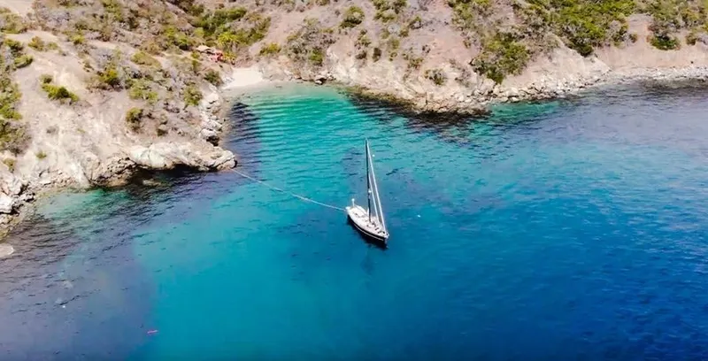 Slide: The Image of Aerial view of 1981 Little Harbor Cruiser anchored in a secluded turquoise bay. - 2
