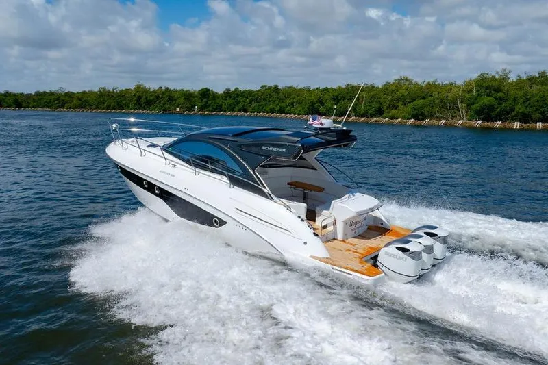 Slide: The Image of 2022 Schaefer 400 Sport yacht cruising on open water under a cloudy sky. - 12