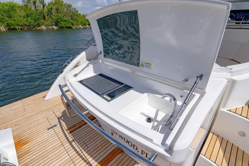 Slide: The Image of Outdoor kitchen on 2022 Schaefer 400 Sport yacht with sink and grill by the water. - 27