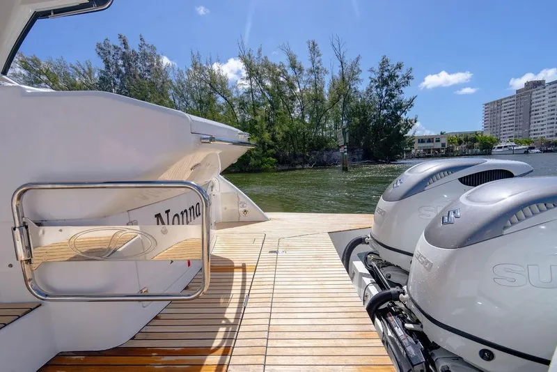 Slide: The Image of 2022 Schaefer 400 Sport yacht with dual outboard motors on a sunny day. - 26