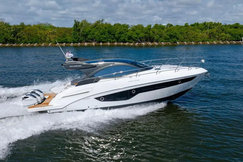 Slide: The Image of 2022 Schaefer 400 Sport yacht cruising on a scenic waterway. - 15