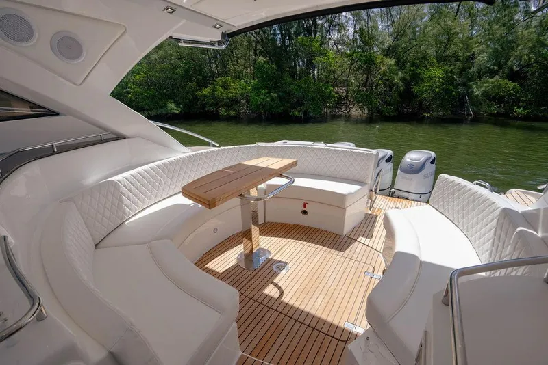Slide: The Image of Luxurious 2022 Schaefer 400 Sport yacht interior with elegant seating and wooden table. - 25
