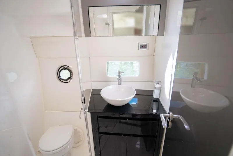 Slide: The Image of Modern bathroom interior on 2022 Schaefer 400 Sport yacht, featuring sleek fixtures and porthole window. - 67
