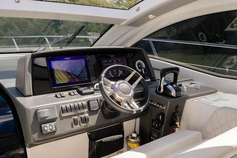 Slide: The Image of Cockpit of 2022 Schaefer 400 Sport yacht with advanced navigation controls and steering wheel. - 37