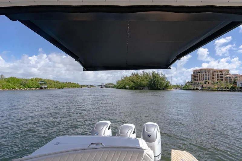 Slide: The Image of View from a 2022 Schaefer 400 Sport boat, overlooking a scenic waterway with lush greenery. - 29