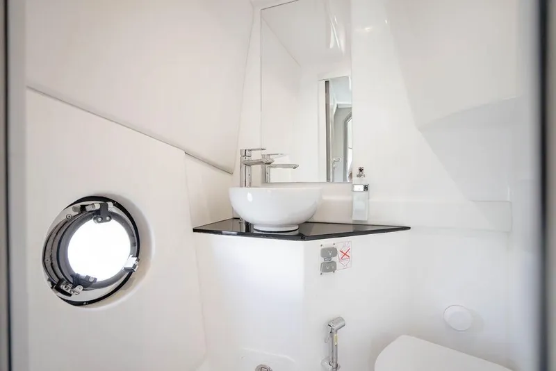 Slide: The Image of Modern bathroom interior of 2022 Schaefer 400 Sport yacht with sleek fixtures and porthole window. - 63