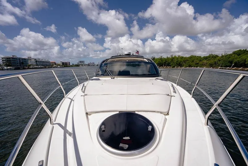 Slide: The Image of 2022 Schaefer 400 Sport yacht cruising on a sunny day with scenic waterfront views. - 48